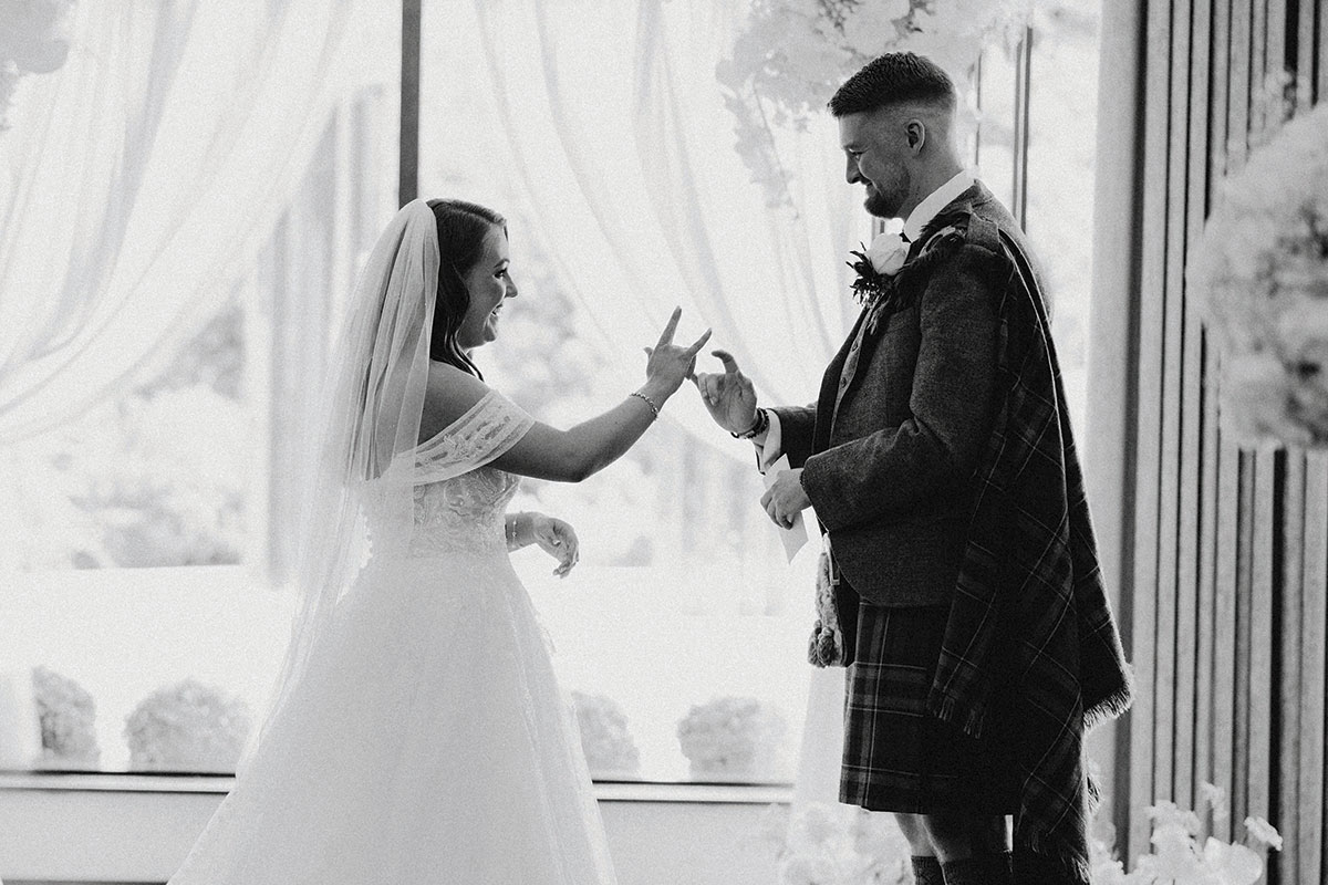 black and white picture of couple doing BSL during wedding ceremony