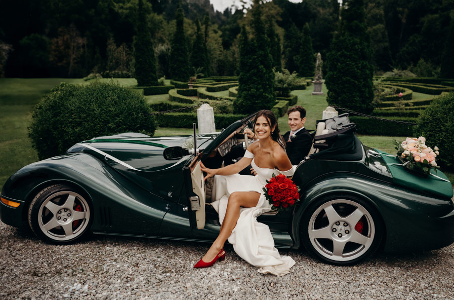 bride and groom sit in classic car at Achnagairn Castle