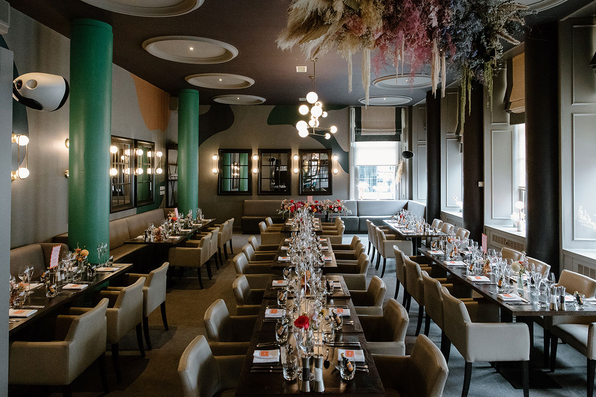 Glaschu Restaurant & Bar in Glasgow set for a wedding meal with long dining tables, floral arrangements and contemporary interiors.