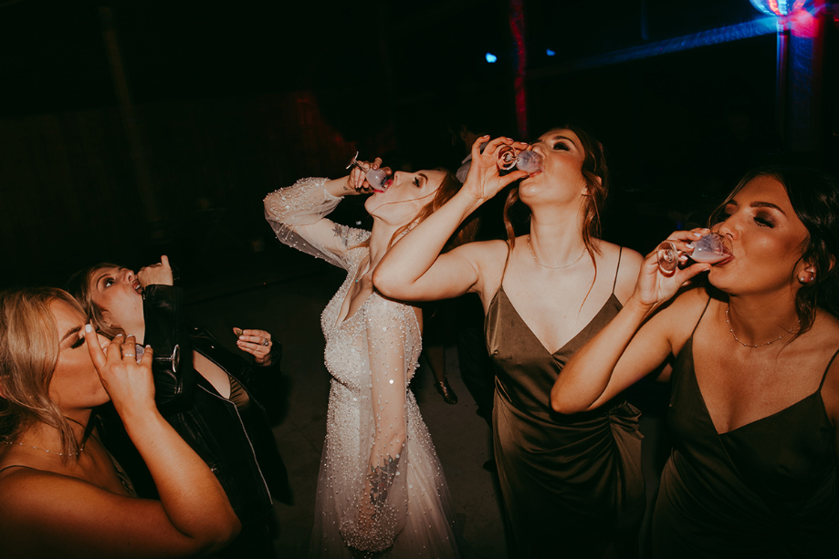 Bride and bridesmaids doing shots