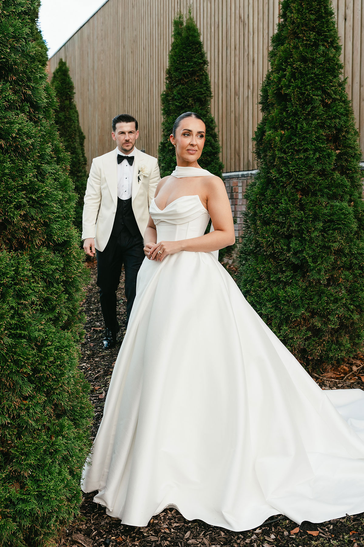 Stylish wedding couple portrait outdoors at Enterkine Country House Ayrshire with greenery and modern architecture