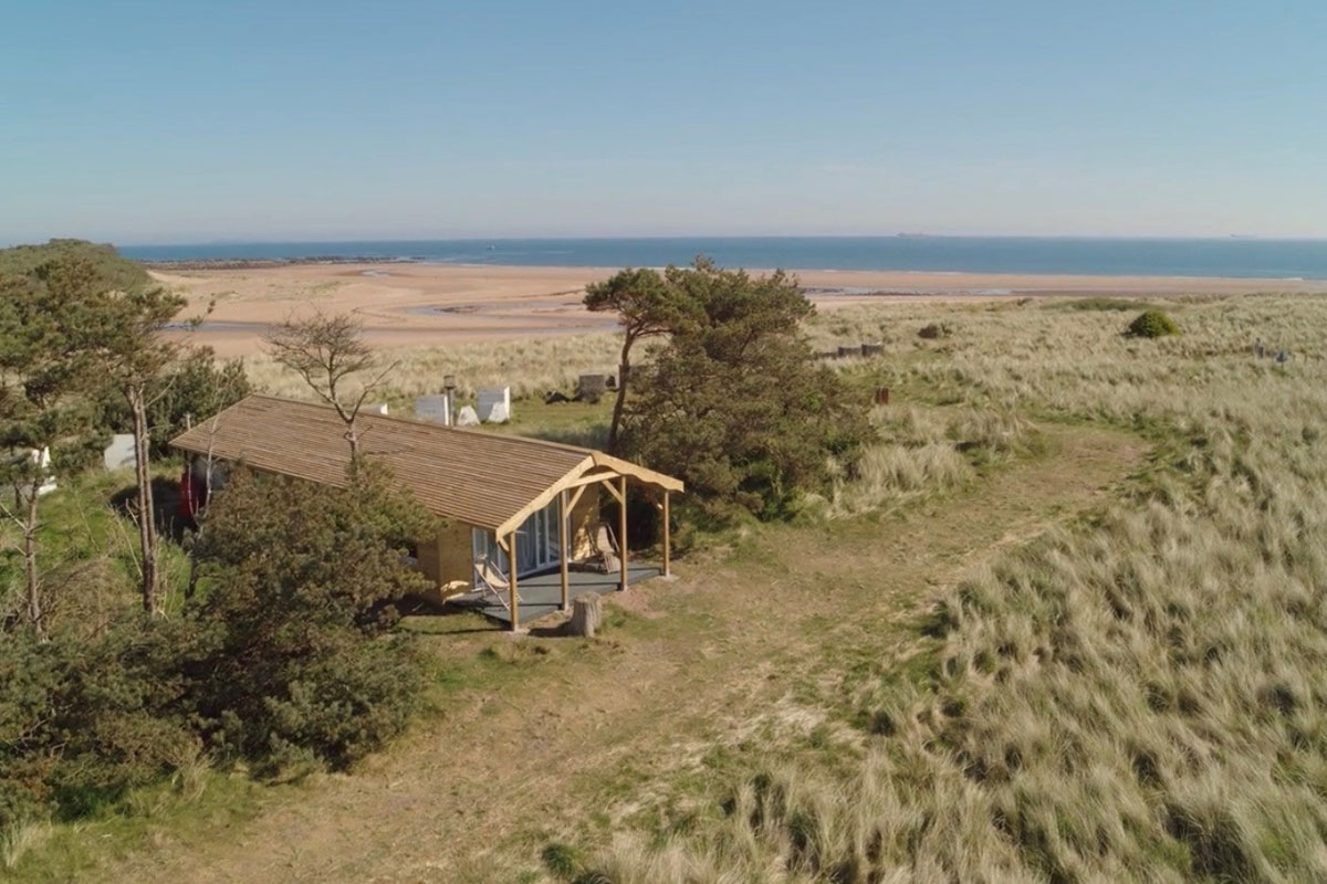 Aerial view of beach cabin accommodation at Harvest Moon Weddings on the East Lothian coastline.