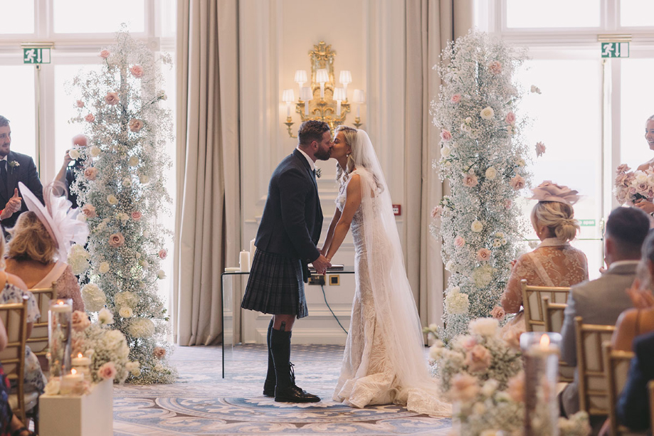 Couple kiss at the end of the wedding ceremony