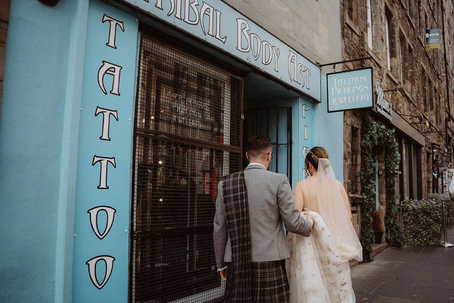 Bride and groom walk into tattoo parlour