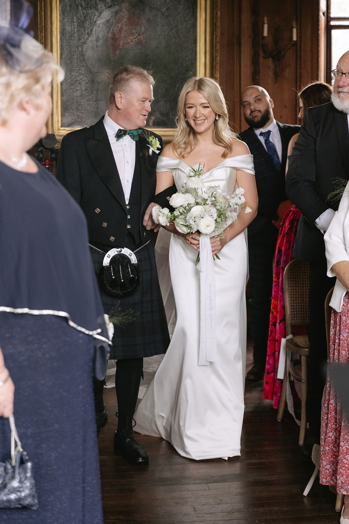 Bride walking down aisle with her father at Gilmerton House indoor wedding ceremony