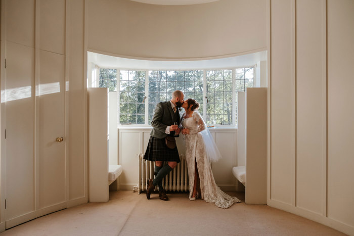 Newlyweds kiss in The Oval Room at House For an Art Lover