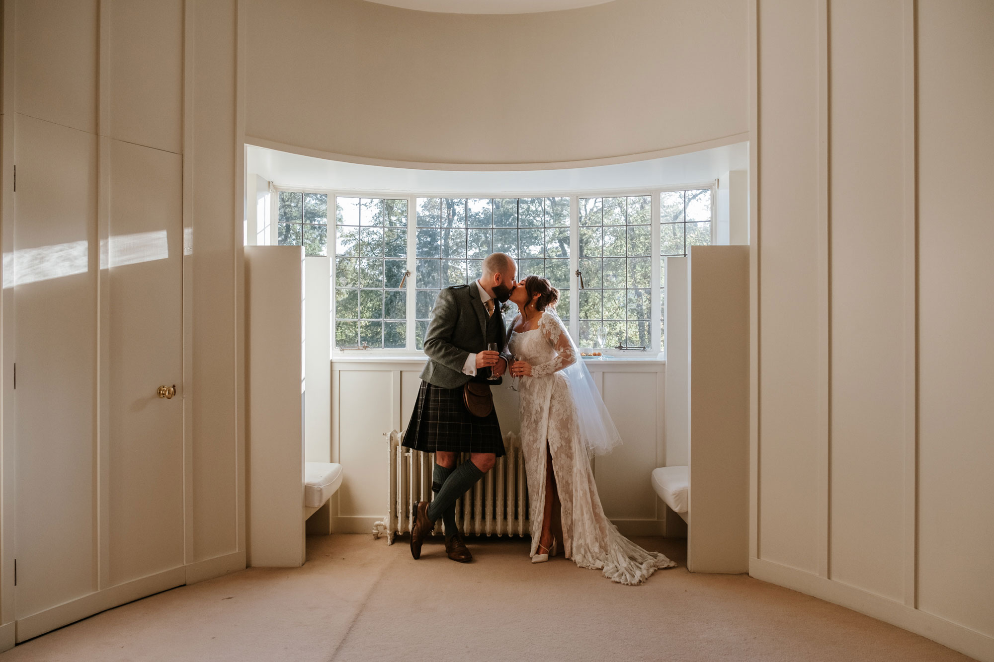 Newlyweds kiss in The Oval Room at House For an Art Lover
