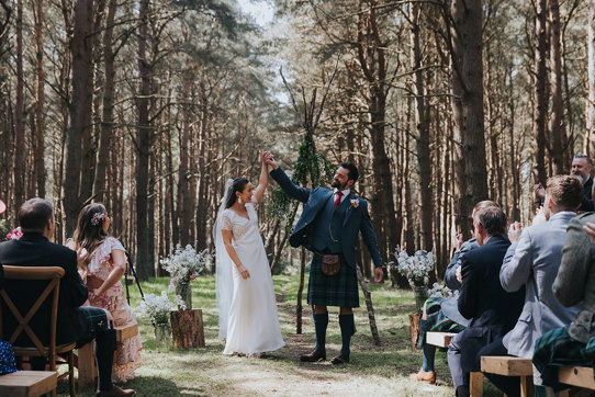 bride and groom have an outdoor woodland ceremony at harvest moon holidays