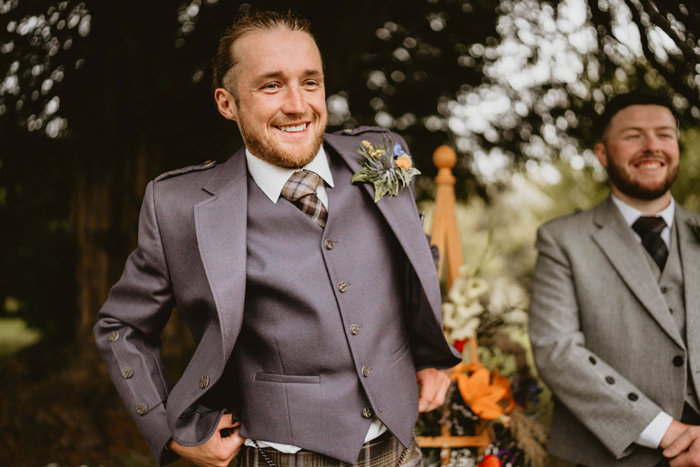Groom waits for bride before outdoor ceremony