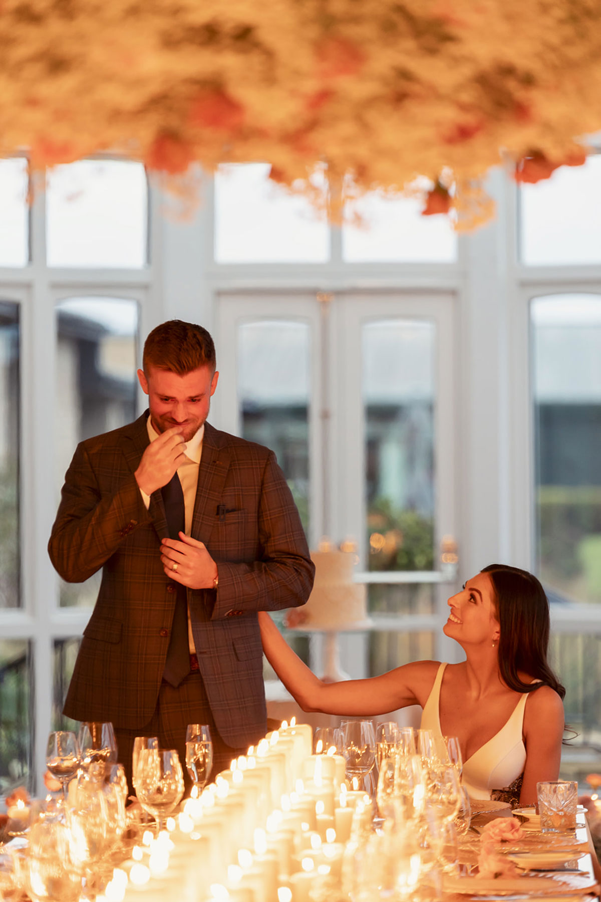 Groom giving an emotional wedding speech beside candlelit tables in the Old Course Hotel conservatory, St Andrews