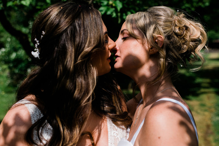 Brides kiss during couple portraits