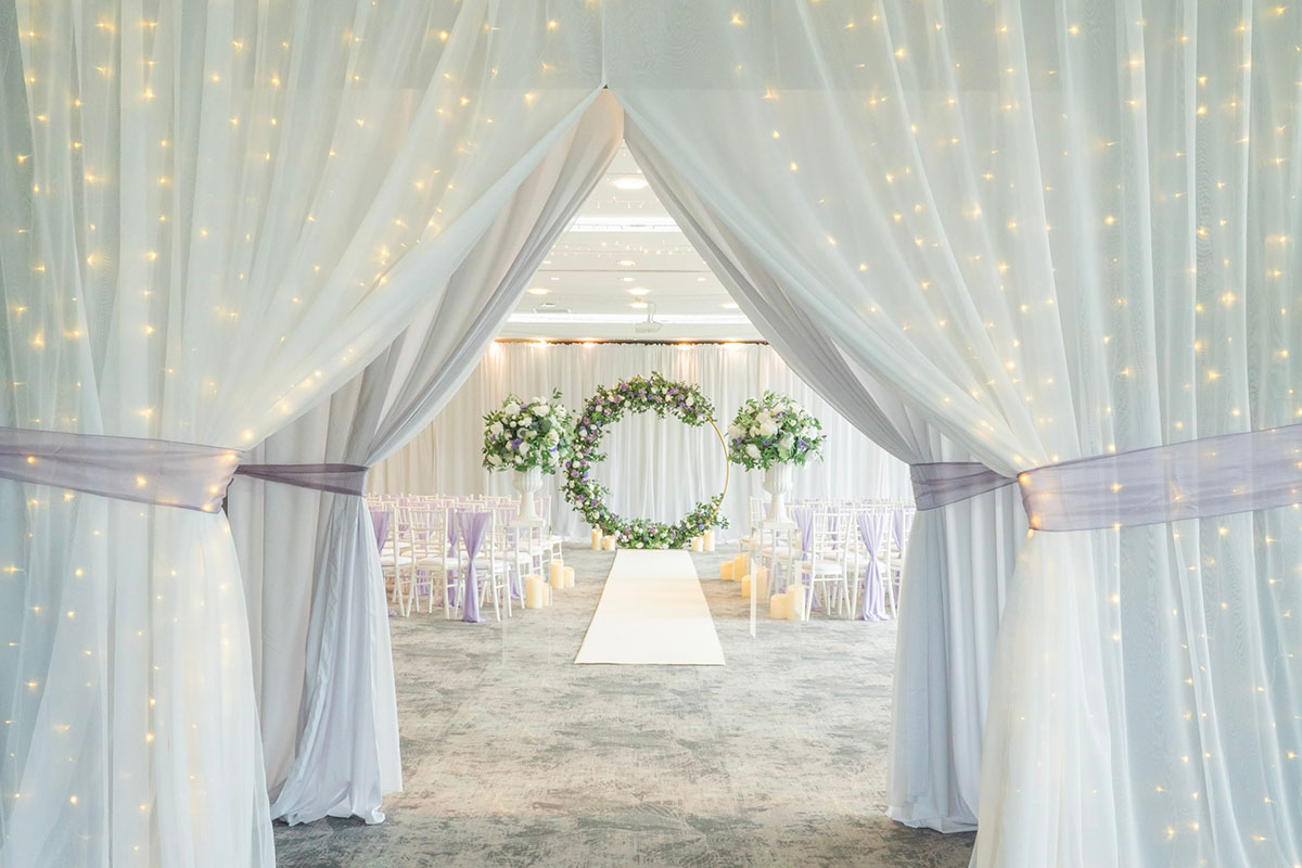 Garden Suite ceremony setup at Norton House Hotel & Spa with fairy lights, florals and white aisle