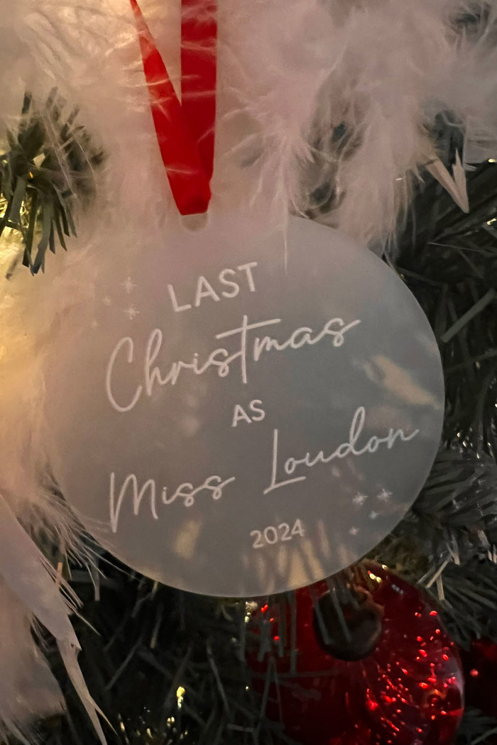 a personalised Christmas decoration reading 'Last Christmas as Miss Loudon 2024'