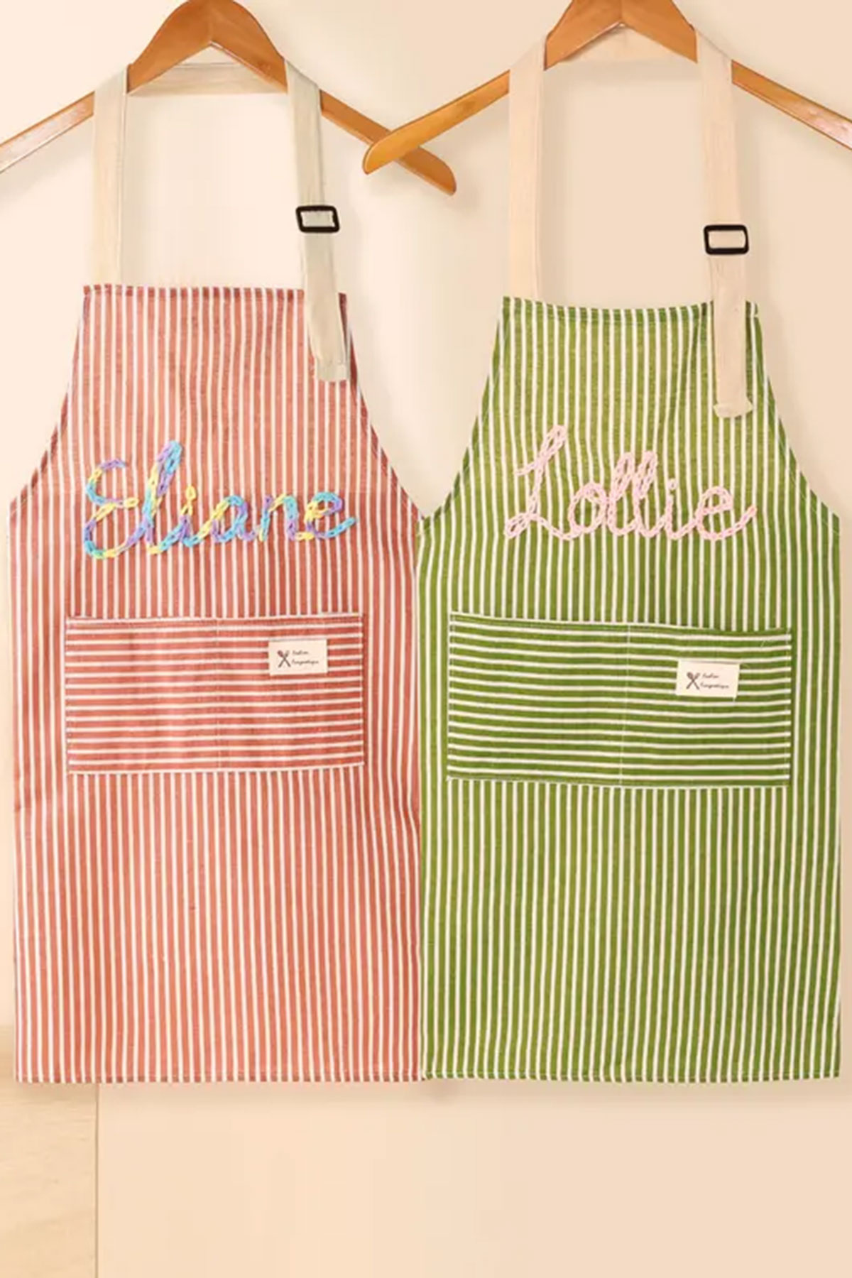 Pair of personalised striped aprons with embroidered names, a fun wedding gift for couples who enjoy cooking together