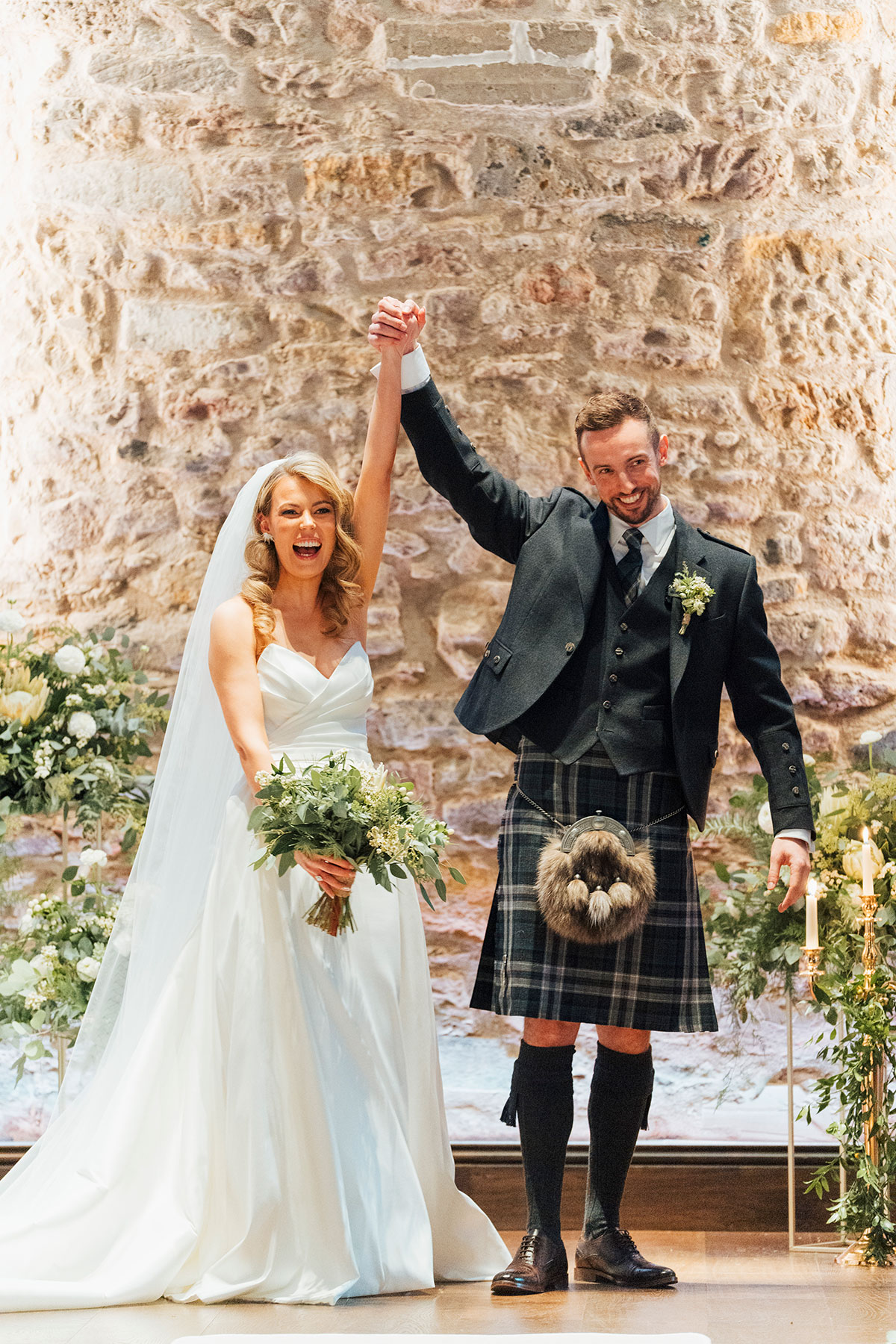 bride and groom cheer after wedding vows said at Virgin Hotels Edinburgh