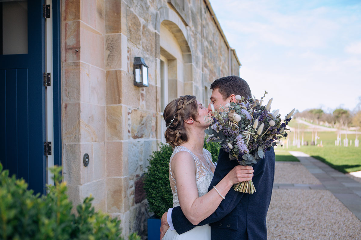 Bride and groom share a kiss