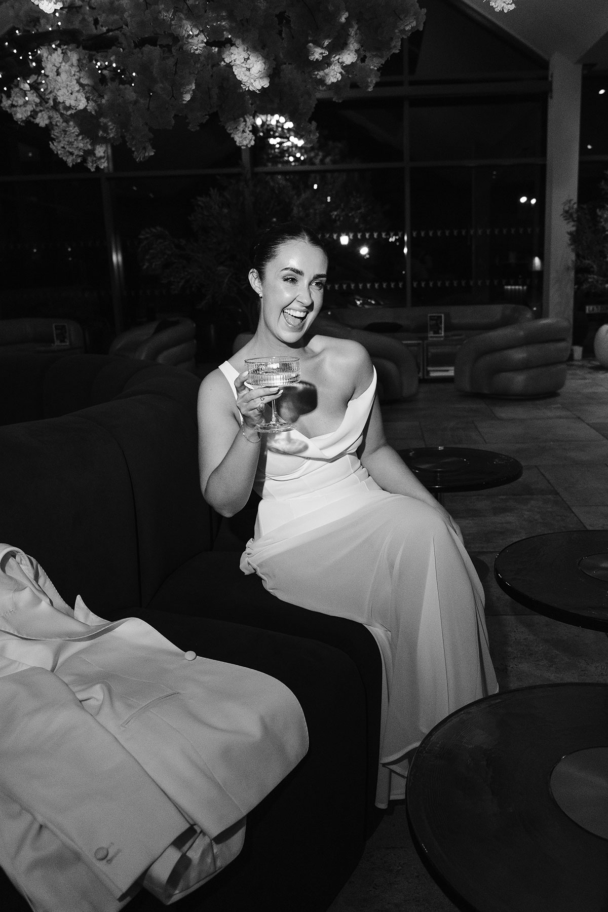 Bride in modern wedding dress holding coupe glass at Enterkine Country House wedding reception Ayrshire