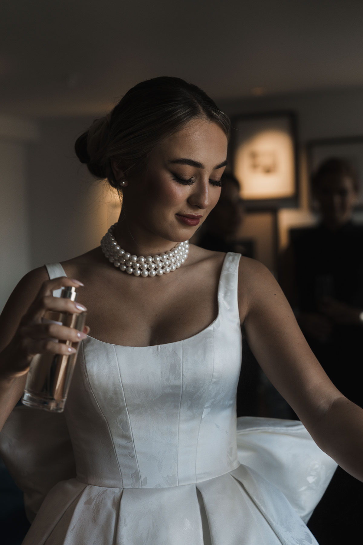 Bride applying perfume during morning preparations before Mansfield Traquair ceremony