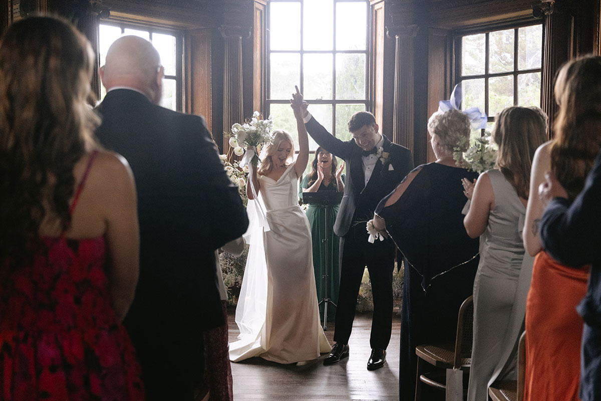 Bride and groom celebrating after ceremony with guests at Gilmerton House wedding venue