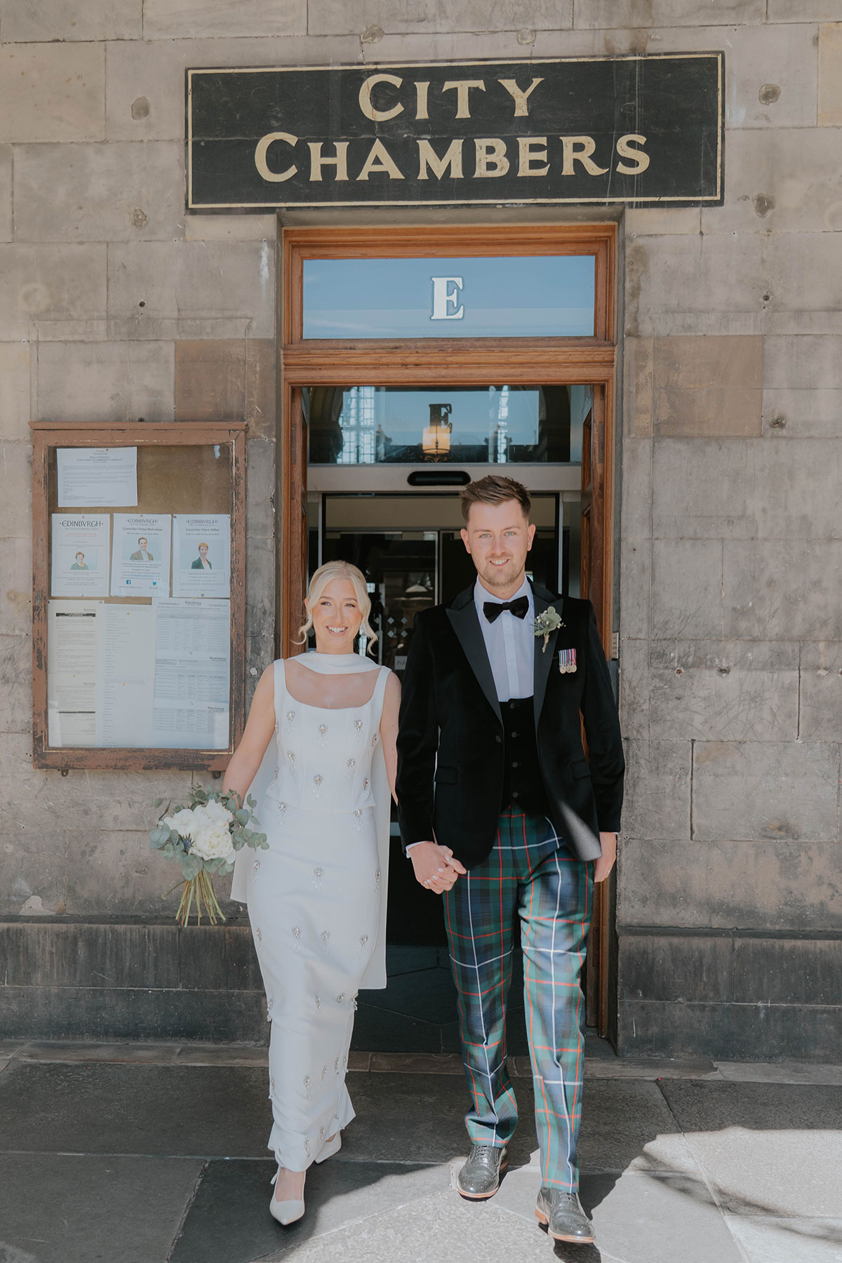 Bride and groom leaving Edinburgh City Chambers after their city centre wedding ceremony