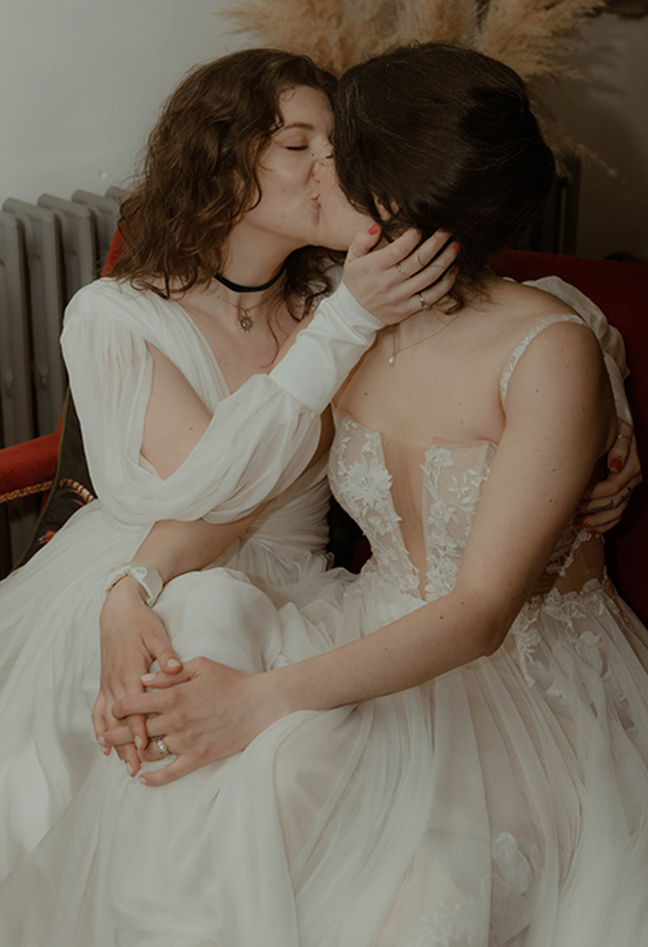 intimate close-up of two brides kissing