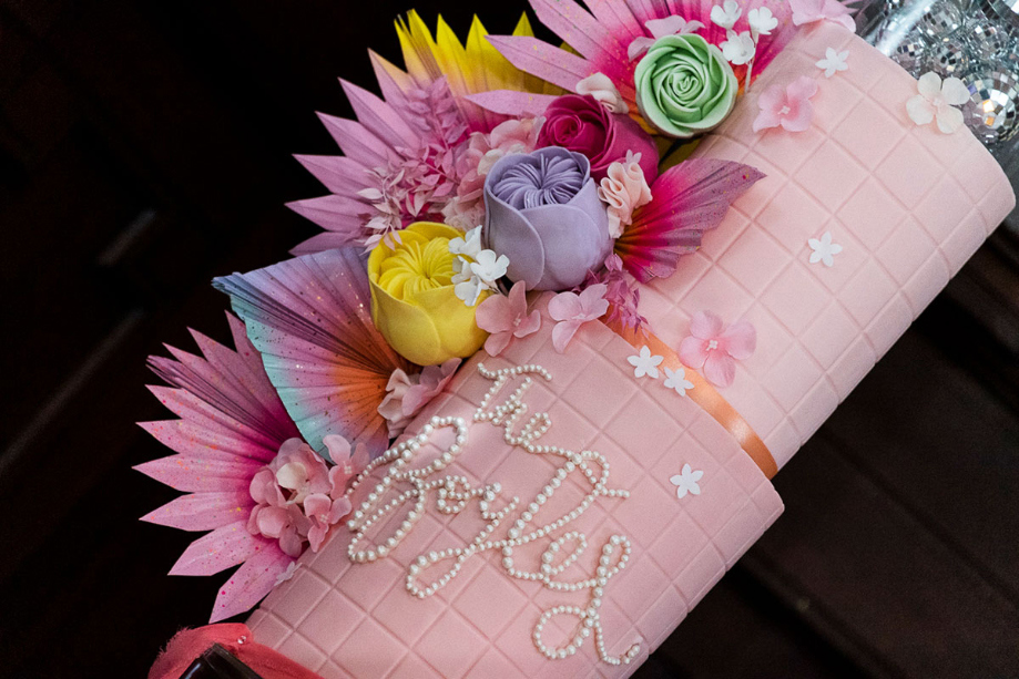 Colourful pink flower wedding cake with 'The Boyles' written in edible pearls made by Cake Days A Week