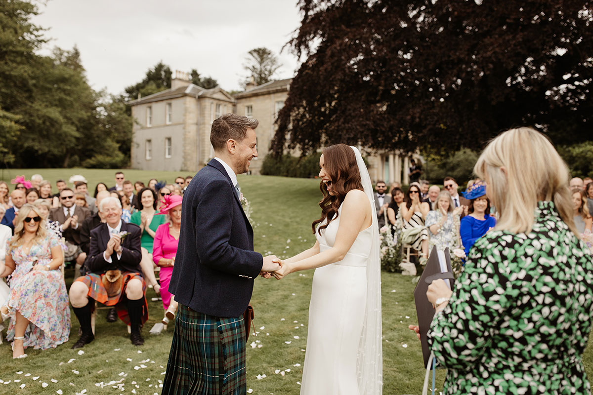 outdoor wedding ceremony of bride and groom at Netherdale House