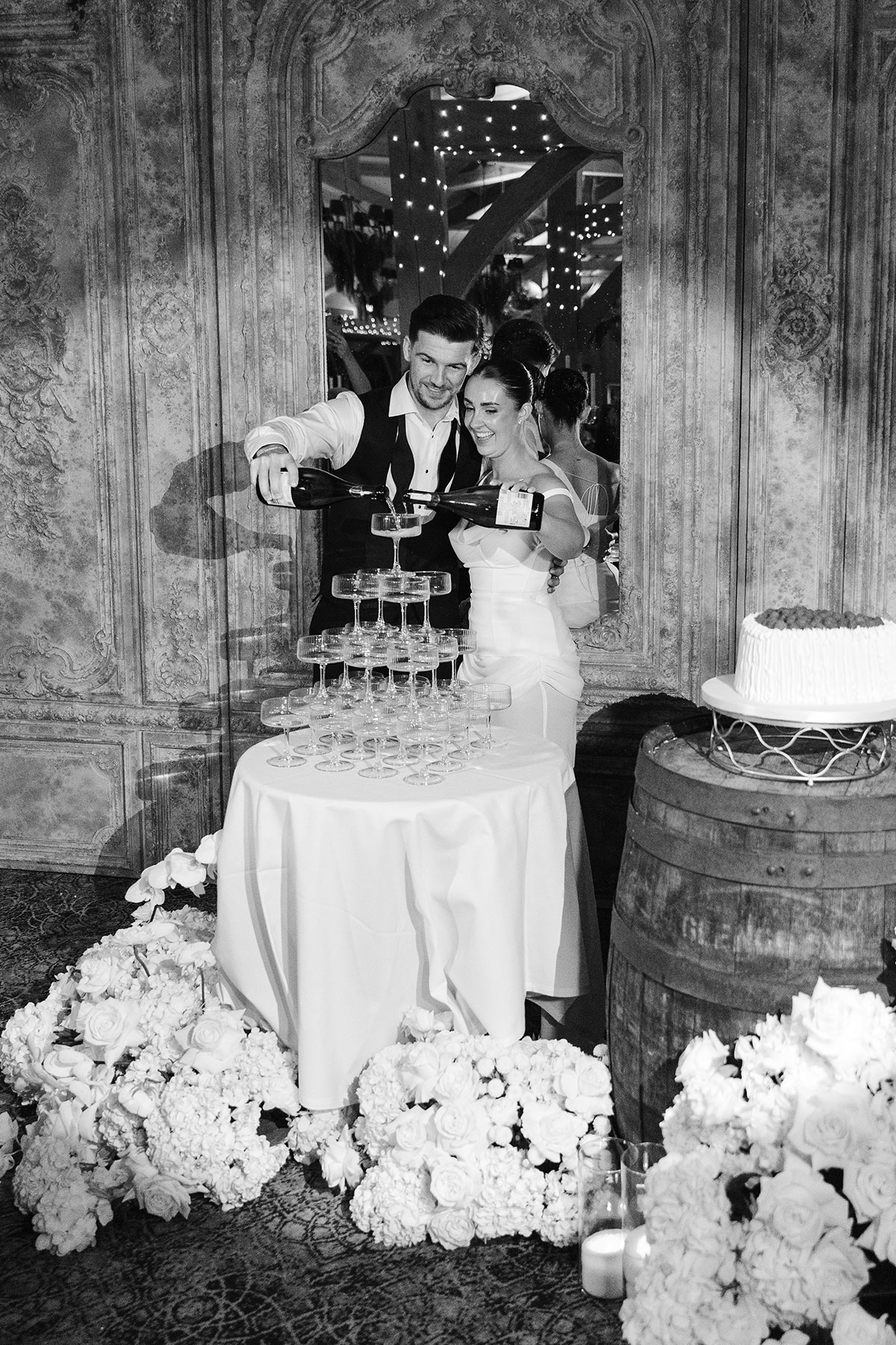 Champagne tower wedding moment with coupe glasses and cake display at Enterkine Country House Ayrshire