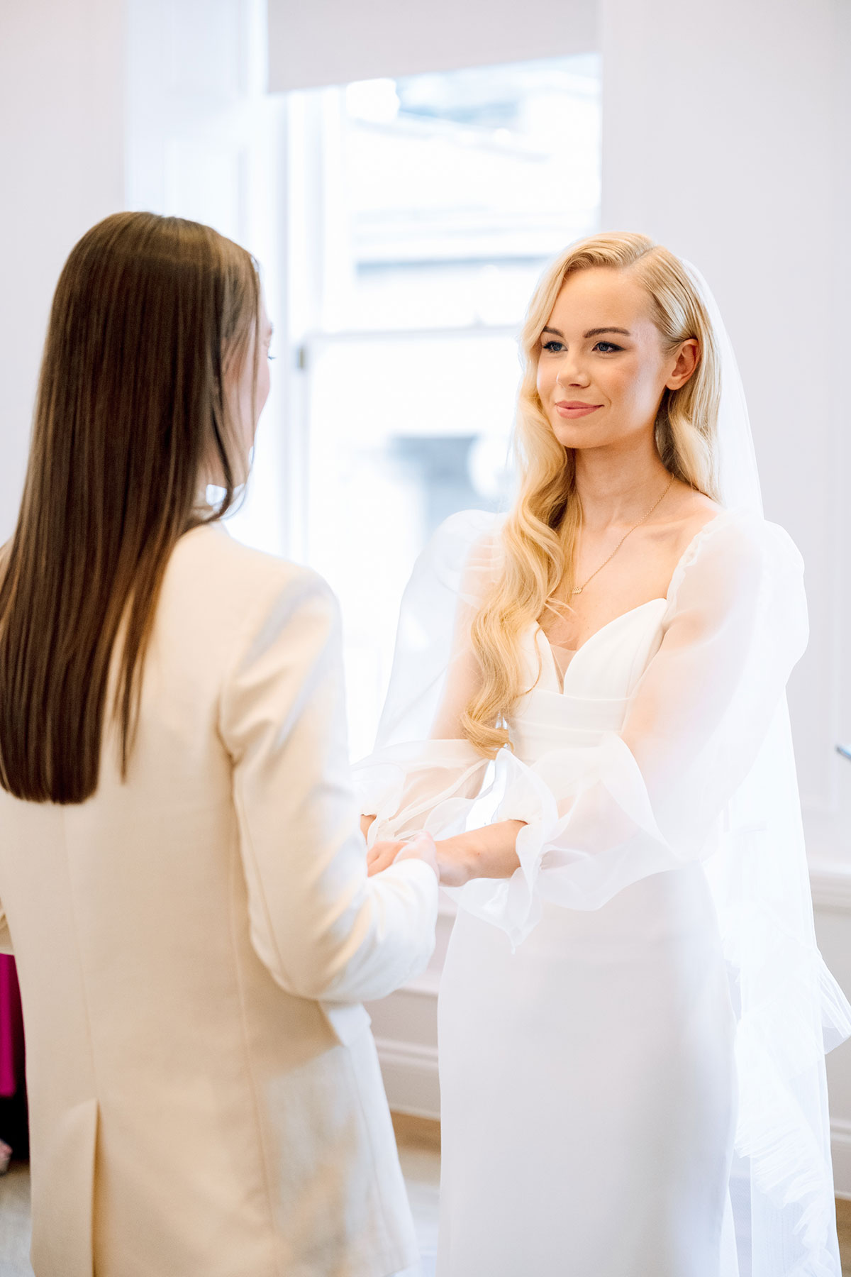 Two brides holding hands during vows, intimate wedding ceremony, The Exchange Glasgow