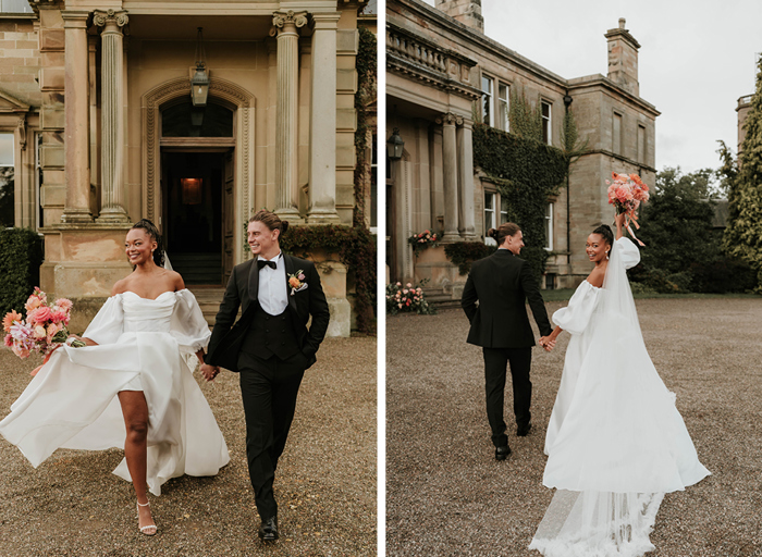 Bride and groom pose hand in hand outside their venue with bouquet in bride's other hand