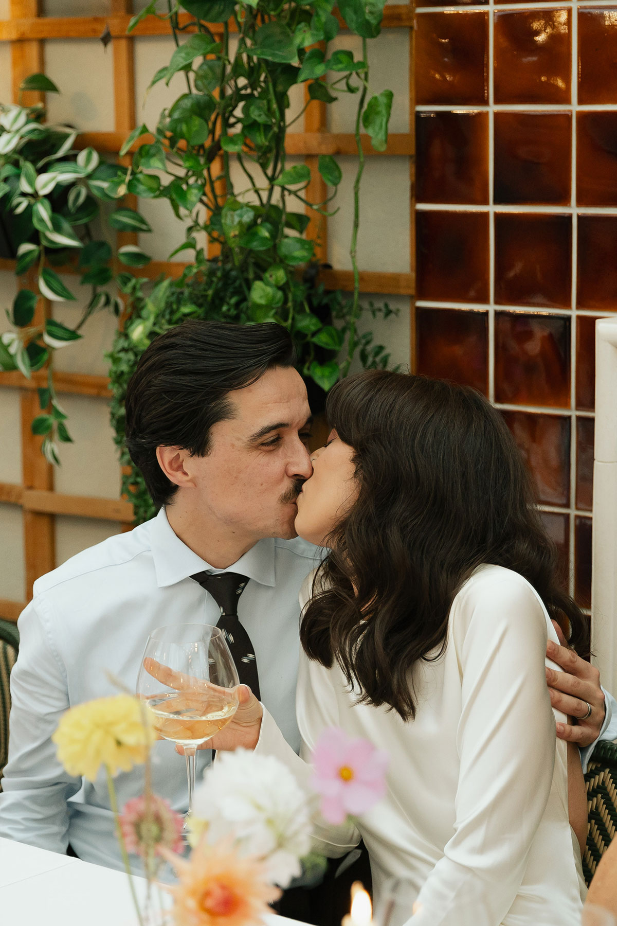 Bride and groom sharing a kiss at Gleneagles Townhouse wedding reception.