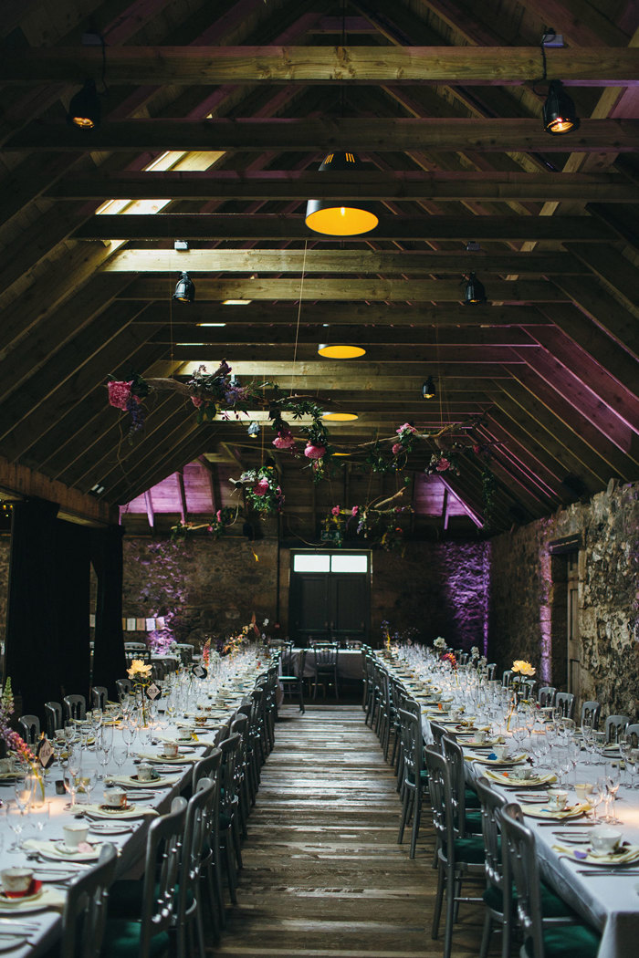 dinner set up at the byre of inchyra with long tables, wine glasses and tea cups