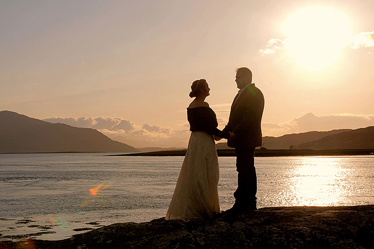 Couple holding hands at sunset