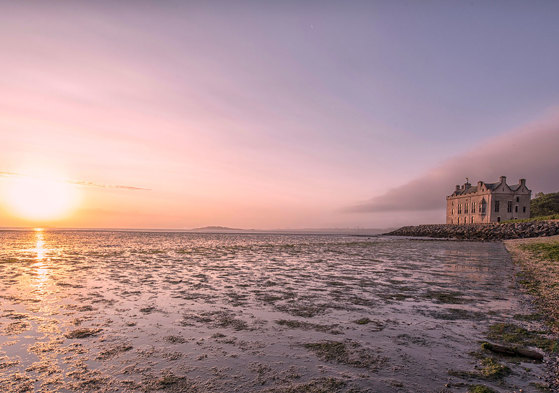Barnbougle Castle seaside coastal wedding venue exterior at sunset
