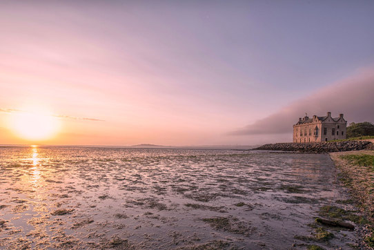 Barnbougle Castle seaside coastal wedding venue exterior at sunset