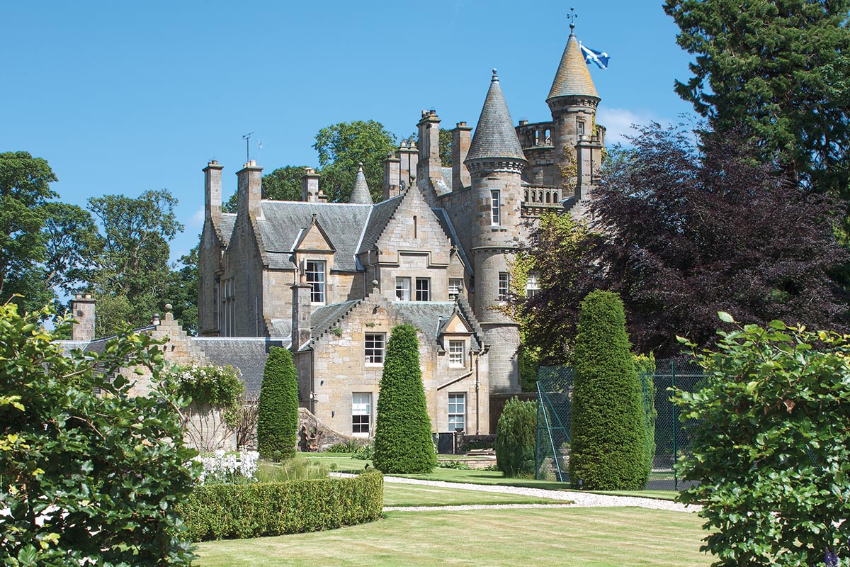 Landscaped gardens at Carlowrie Castle near Edinburgh, with manicured lawns, flower borders and castle beyond
