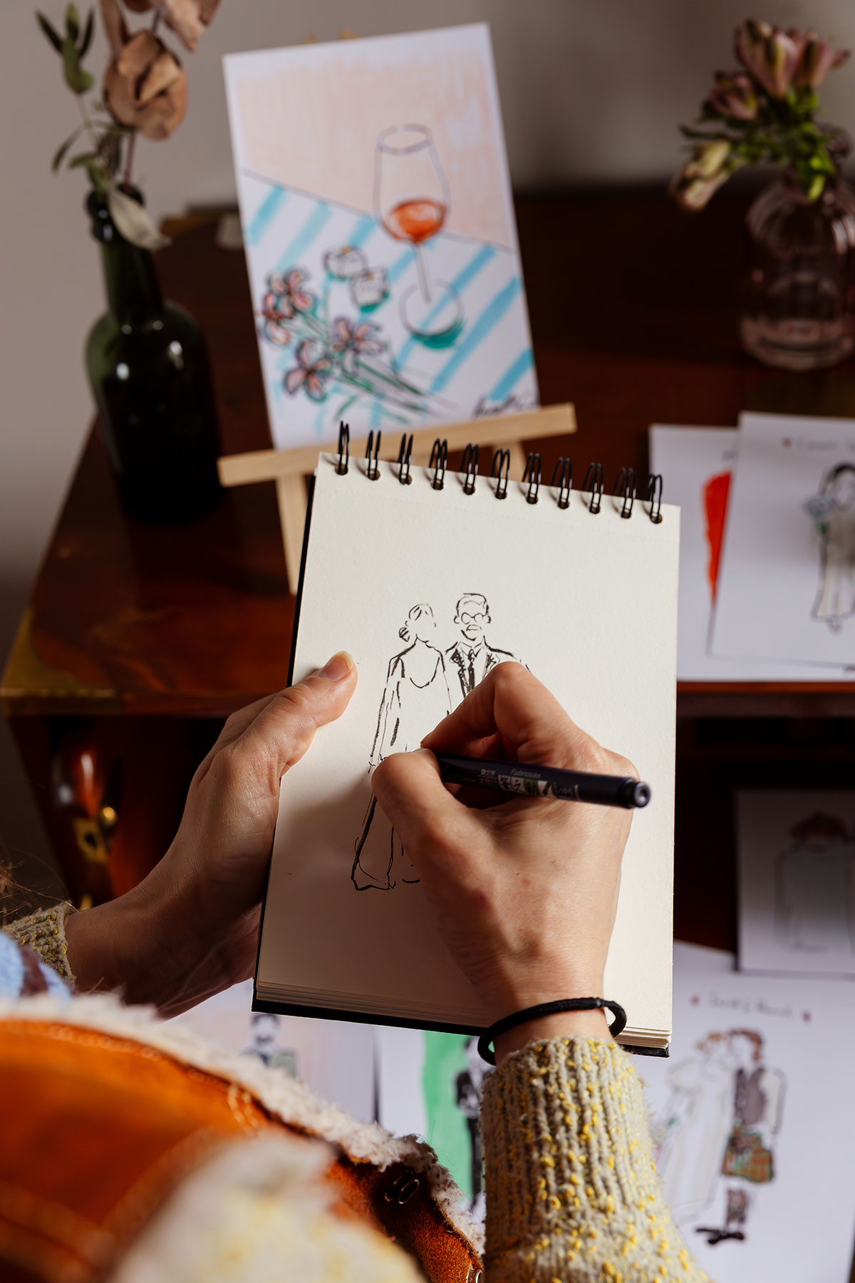 Wedding illustrator sketching couple during planning session at The Tower Portobello