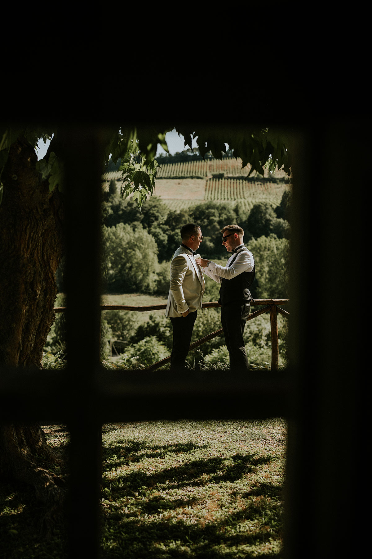 Groom getting ready overlooking Tuscan countryside at Antico Borgo San Lorenzo wedding