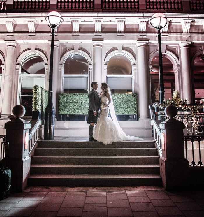 couple on stairs at night in front of Glasgow Grosvenor Hotel