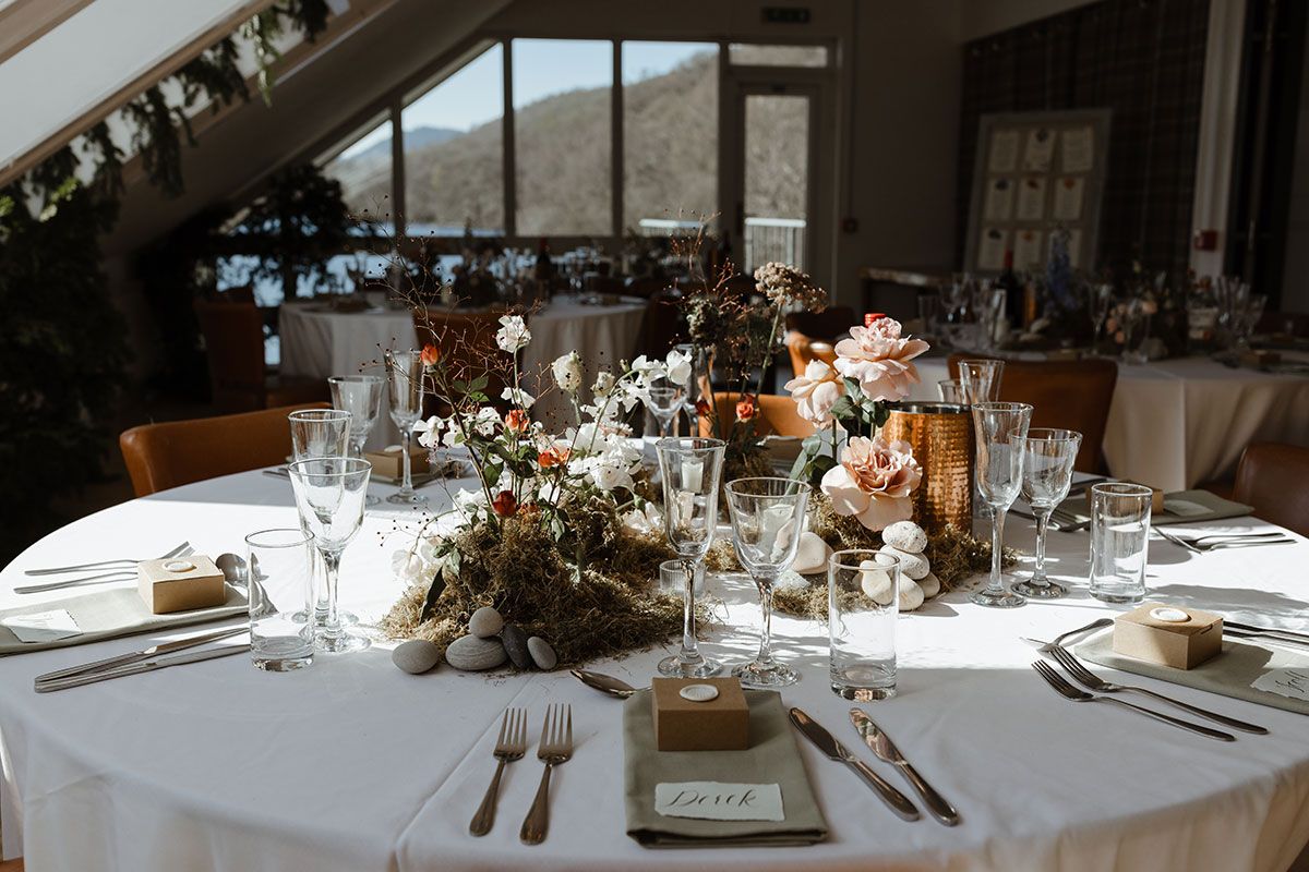 The indoor table settings and decor, including place settings and floral arrangements in the centre