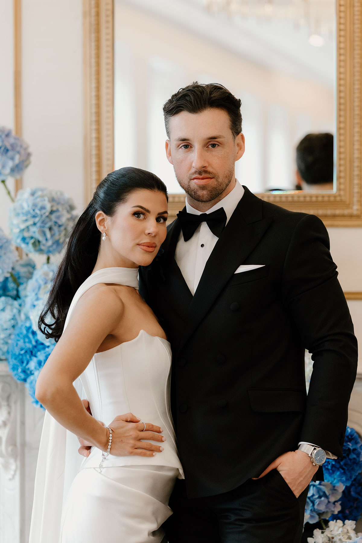 Bride and groom posing at The Exchange Glasgow wedding with blue hydrangea flower arrangement