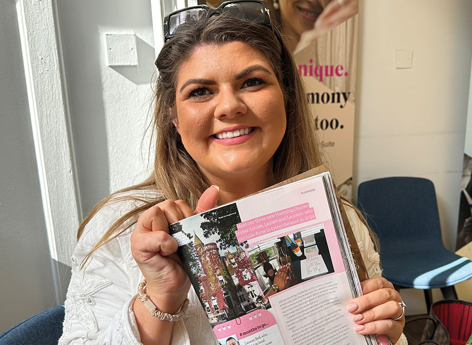 woman smiling holding up magazine