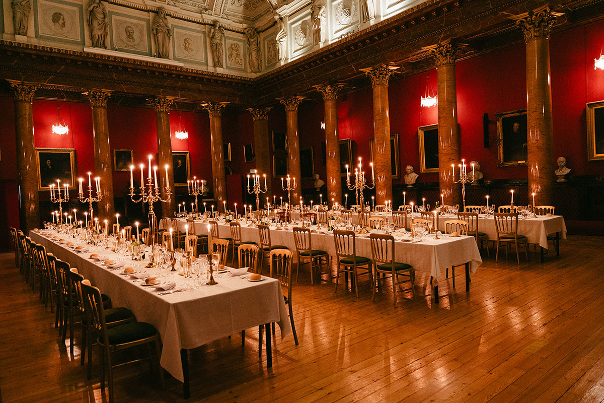 Candlelit wedding dinner setup in the Great Hall at the Royal College of Physicians of Edinburgh