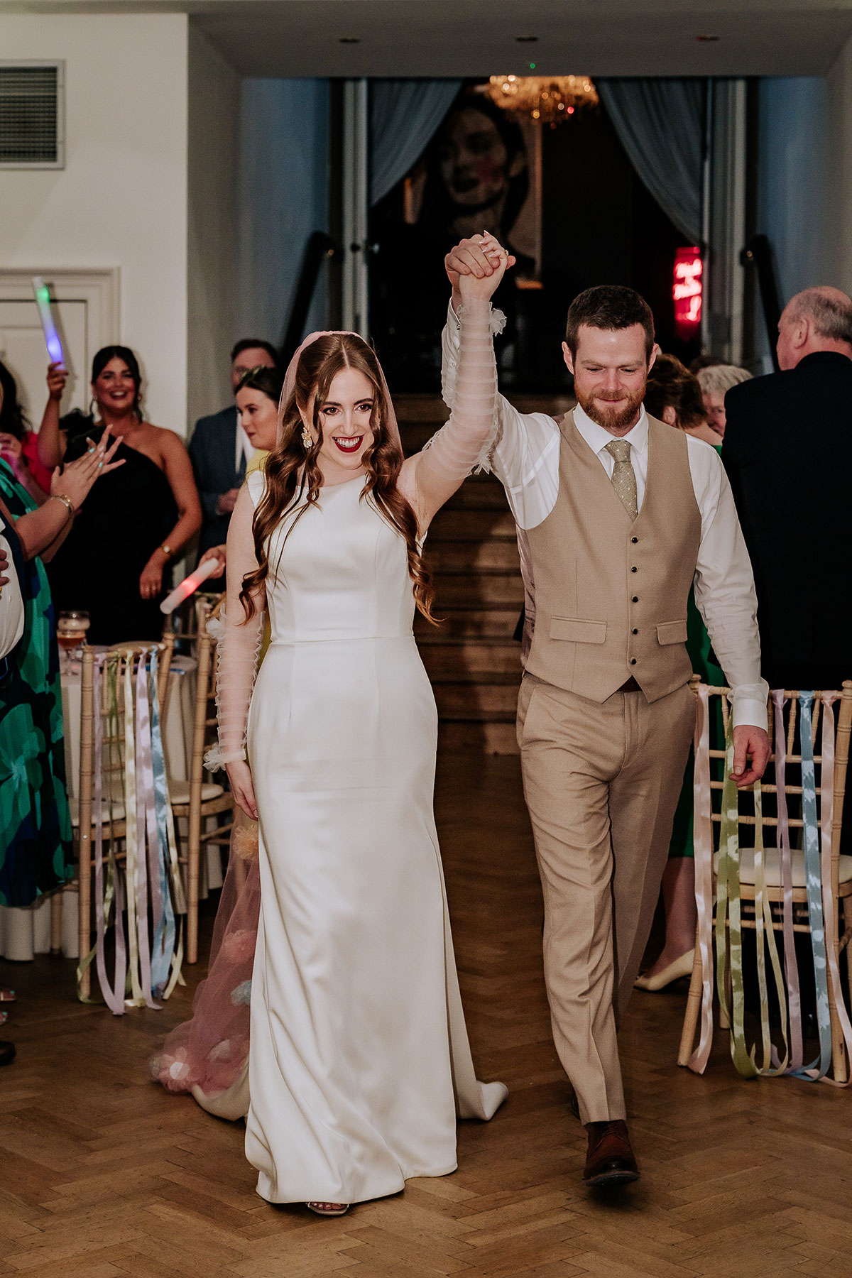 a bride and groom entering wedding reception at Carlowrie Castle