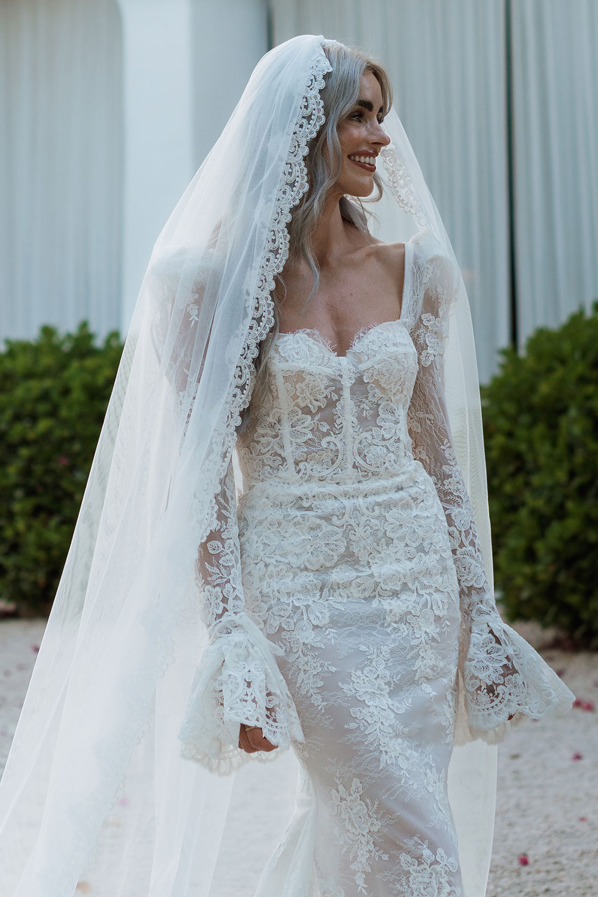 Bride in lace wedding dress and veil by Carolyn Baxter Bridal at Ibiza destination wedding venue Can Rafal