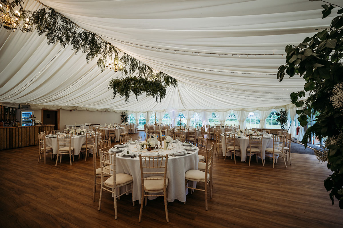 Marquee At Boswells Estate Dressed For A Wedding With Round Tables And Chiavari Chairs