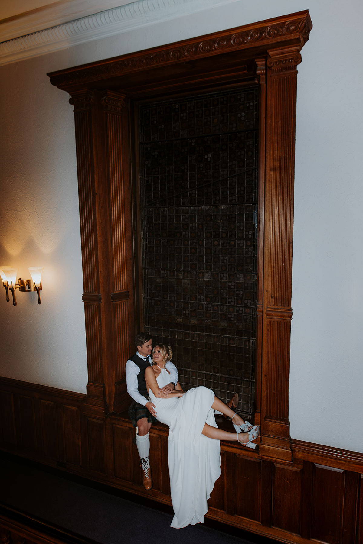 bride and groom sit in alcove at ardoe house wedding