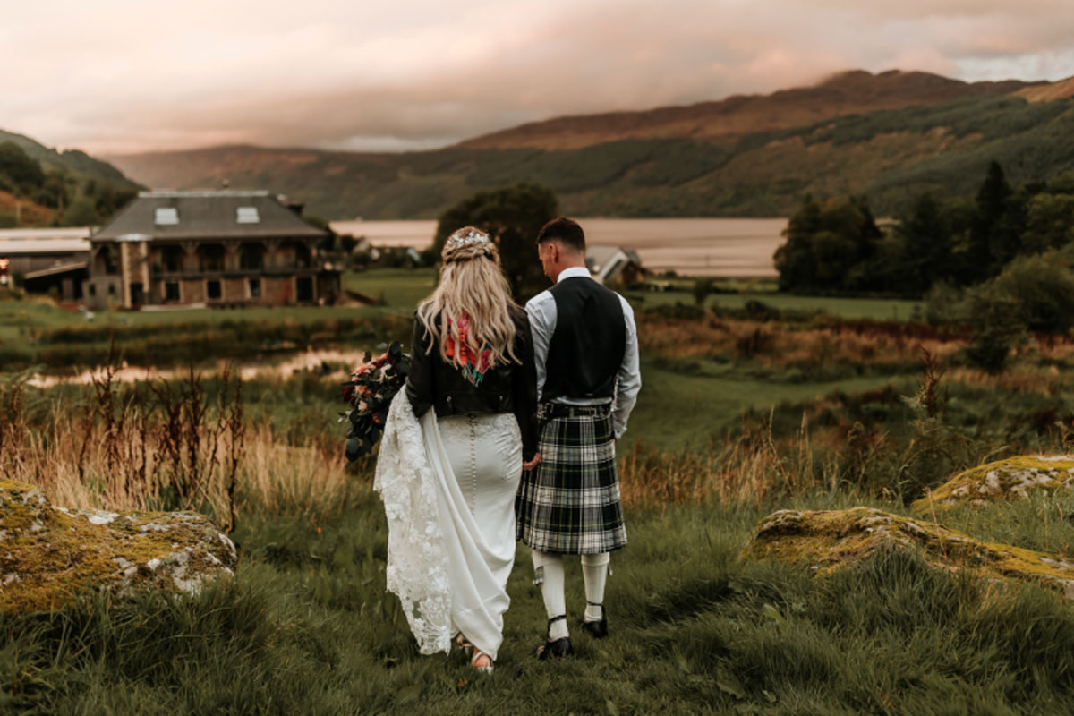 Carrick Castle Estate Argyll wedding venue exterior view with bride and groom walking 