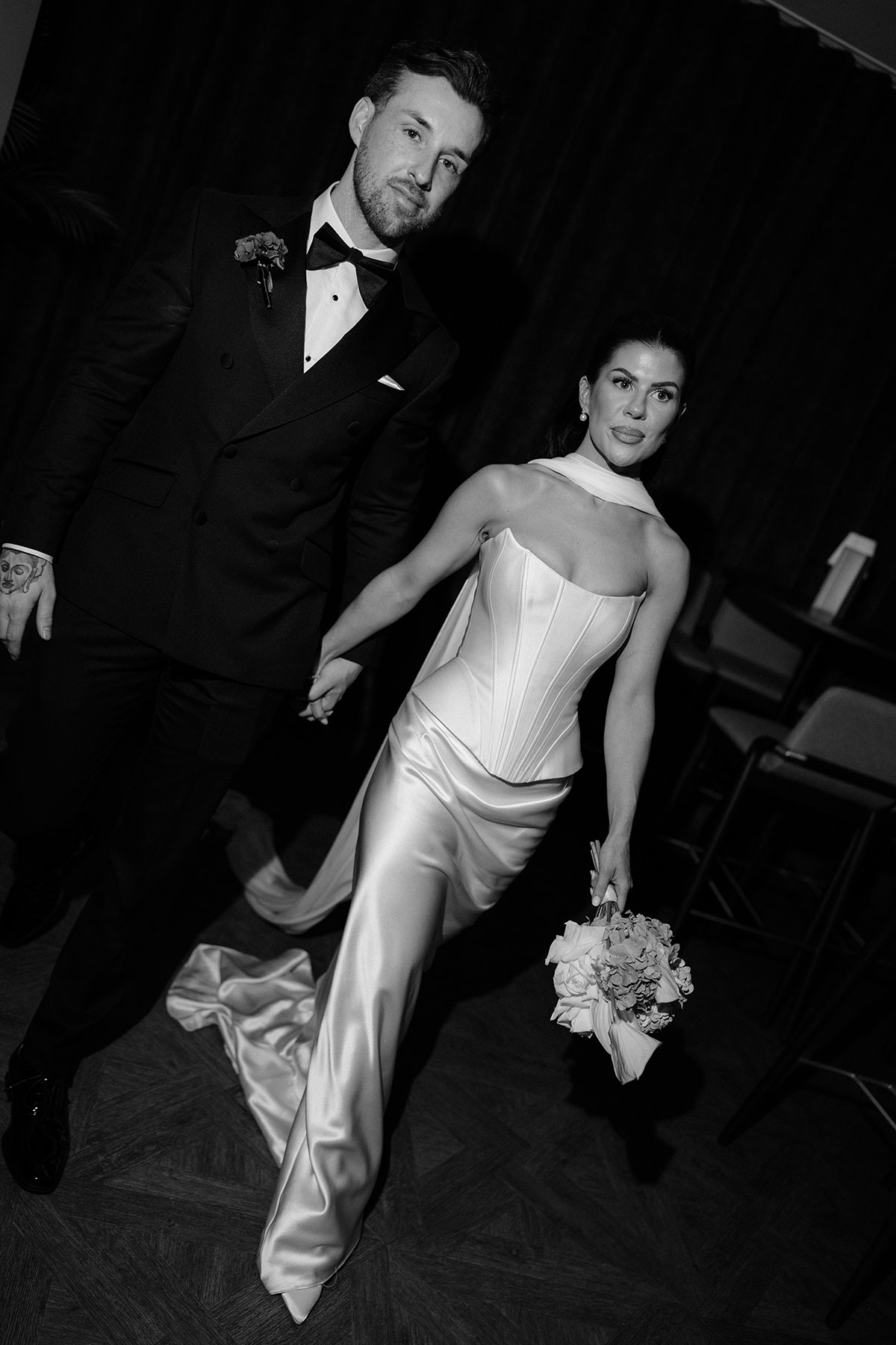 Bride and groom holding hands at The Exchange Glasgow wedding, black and white portrait 