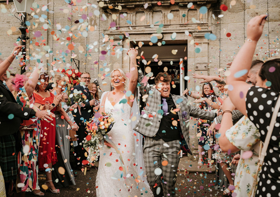 Couple emerge from venue to a confetti shower